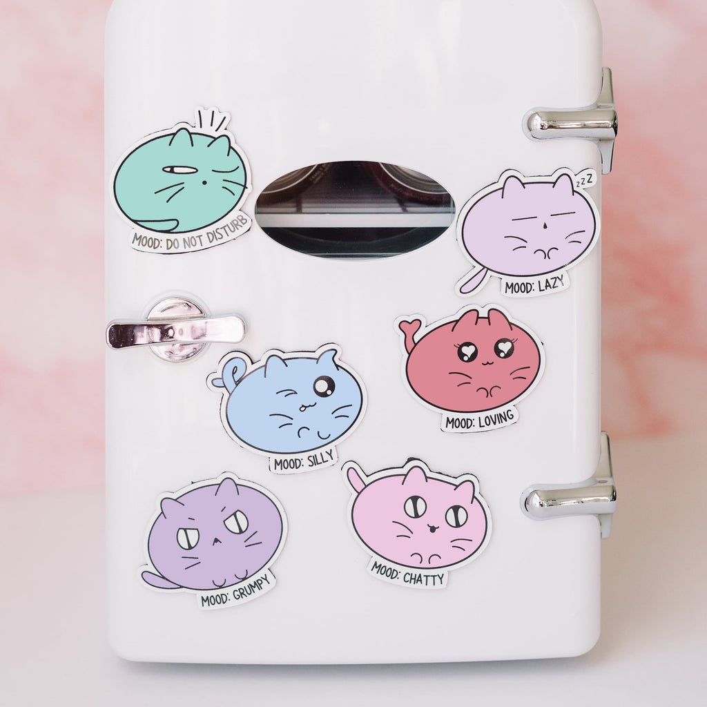 cat magnets on a small fridge