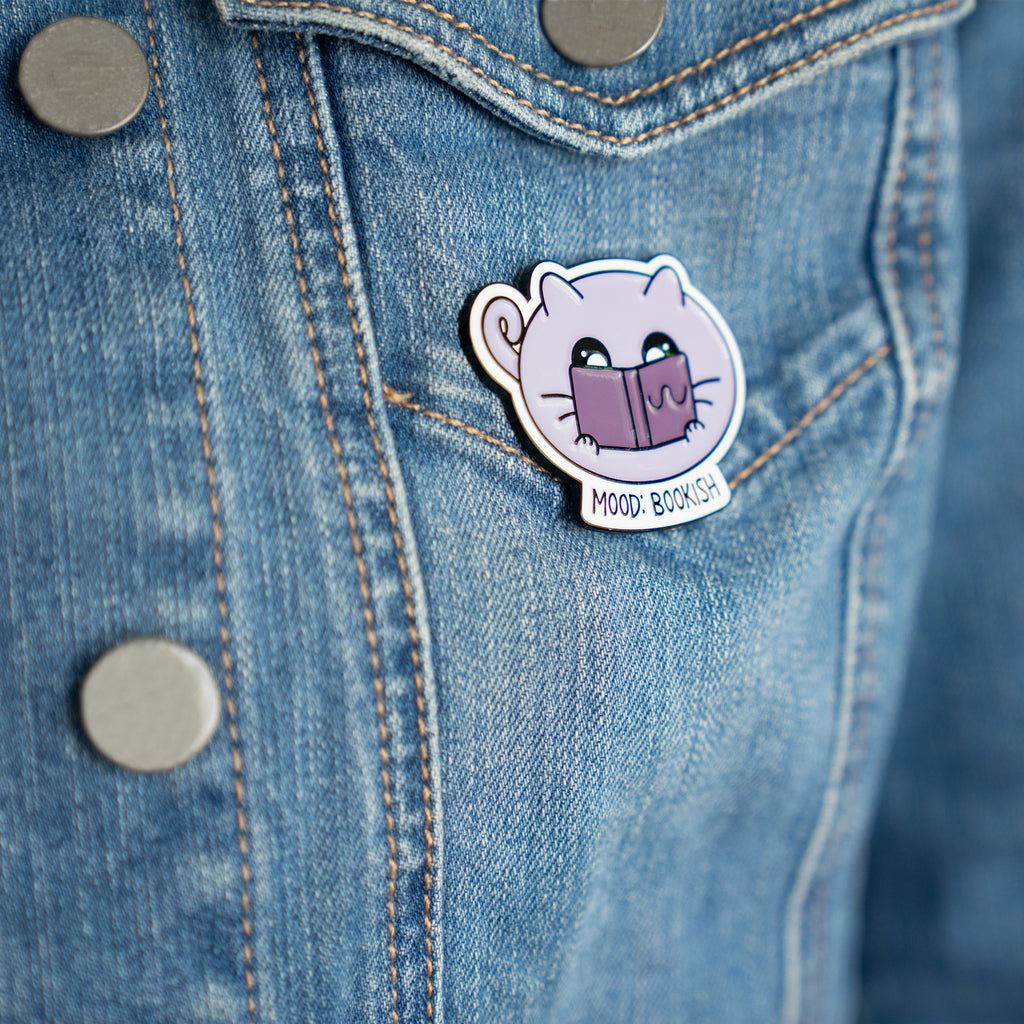 Cat Bookish Pin on a denim jacket