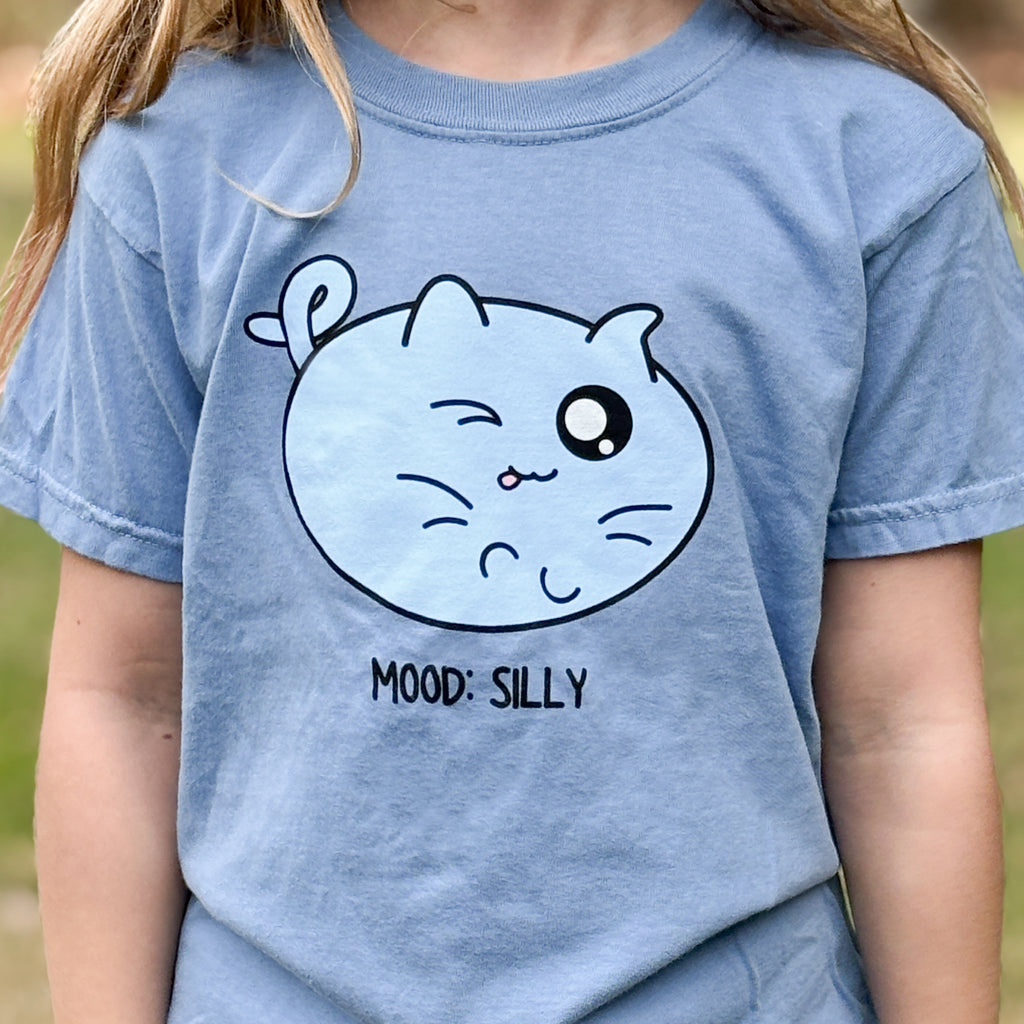 shirt with a cat illustration of a cat in with its tongue out and mood silly words